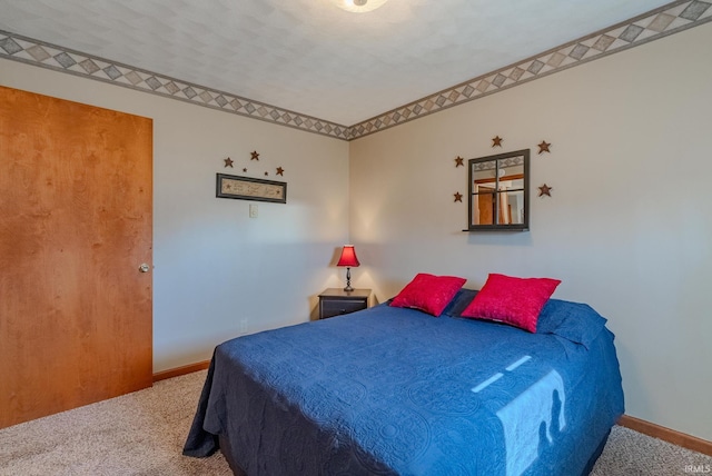 carpeted bedroom featuring baseboards