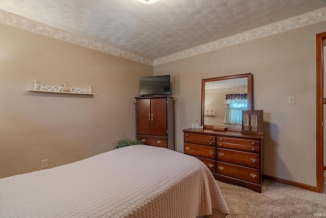 carpeted bedroom featuring baseboards