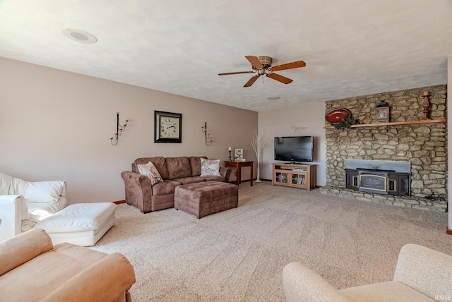 carpeted living area with a textured ceiling and ceiling fan