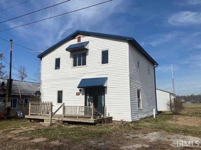 back of house featuring a wooden deck