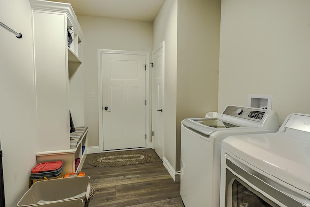 clothes washing area with laundry area, independent washer and dryer, baseboards, and dark wood-style flooring