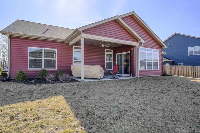 rear view of property with a yard, a patio, ceiling fan, and fence