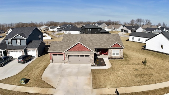 view of front facade with a shingled roof, a residential view, concrete driveway, a garage, and stone siding