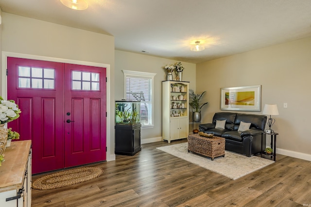 foyer entrance with visible vents, baseboards, and wood finished floors