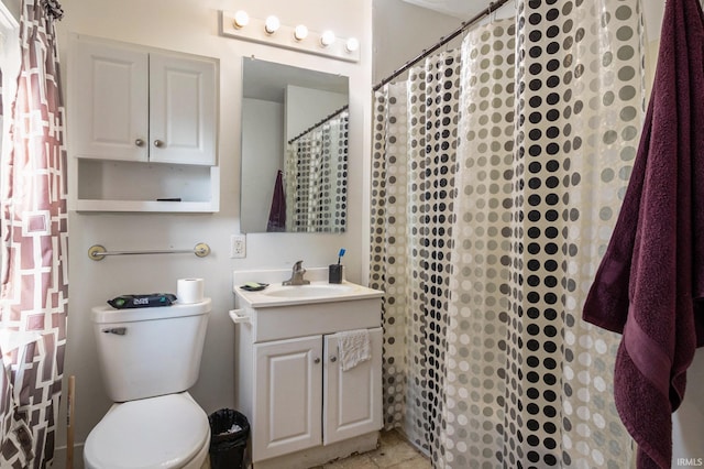 bathroom featuring curtained shower, toilet, and vanity