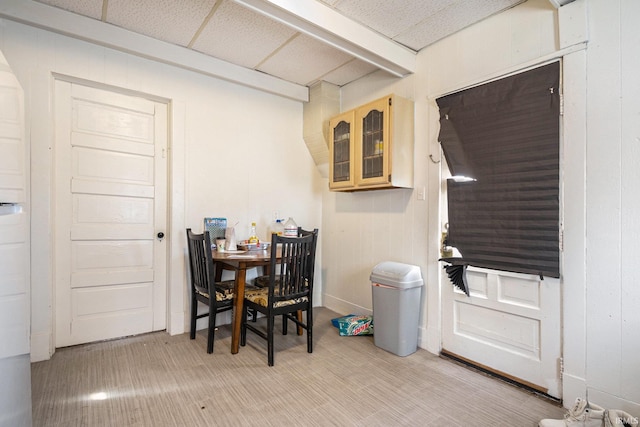 dining space with a paneled ceiling