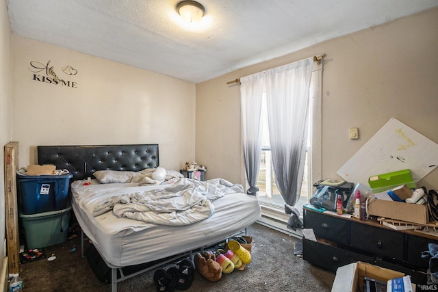 bedroom with a textured ceiling and carpet