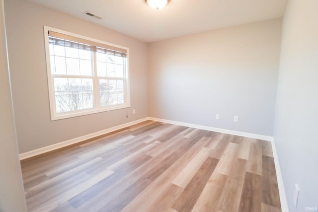 unfurnished room with visible vents, baseboards, and light wood-style floors