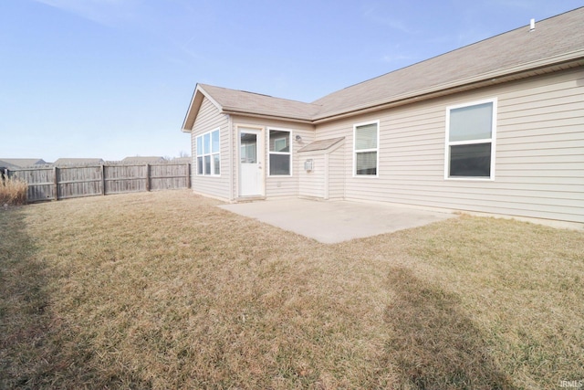 back of house with a patio, a lawn, and fence