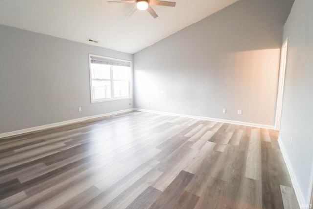 unfurnished room with a ceiling fan, baseboards, visible vents, vaulted ceiling, and light wood-type flooring