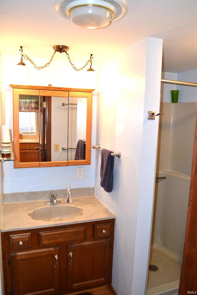 bathroom with a stall shower and vanity