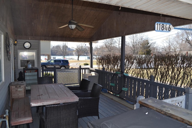 deck featuring outdoor dining area and ceiling fan