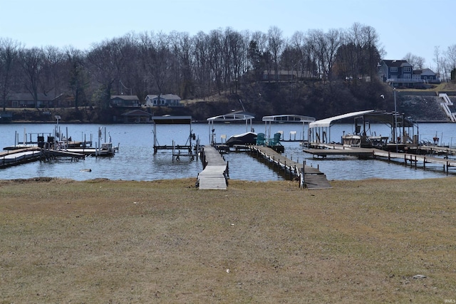 view of dock featuring a yard, a water view, and boat lift