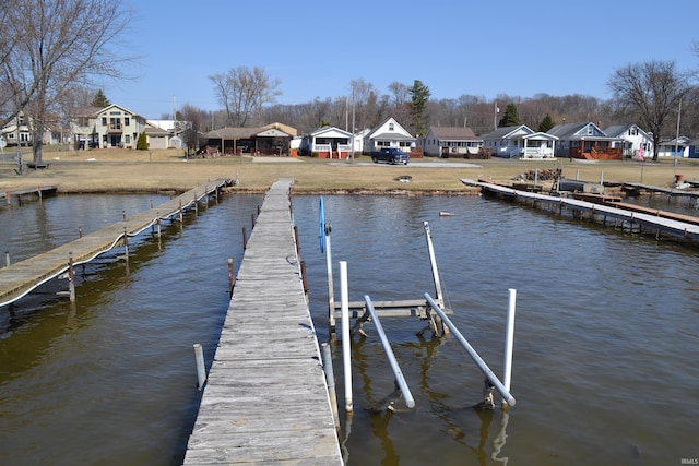 dock area with a residential view and a water view