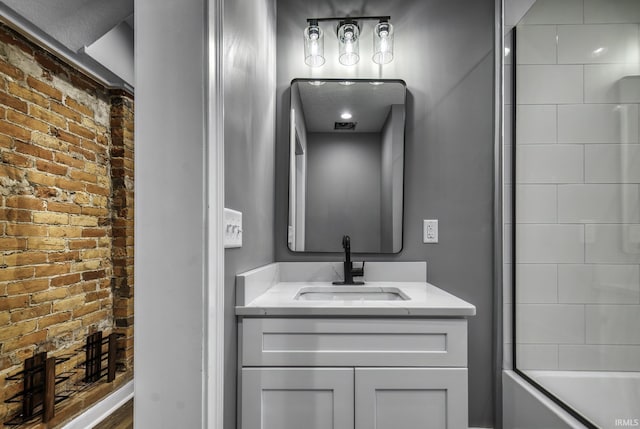 full bath with brick wall and vanity