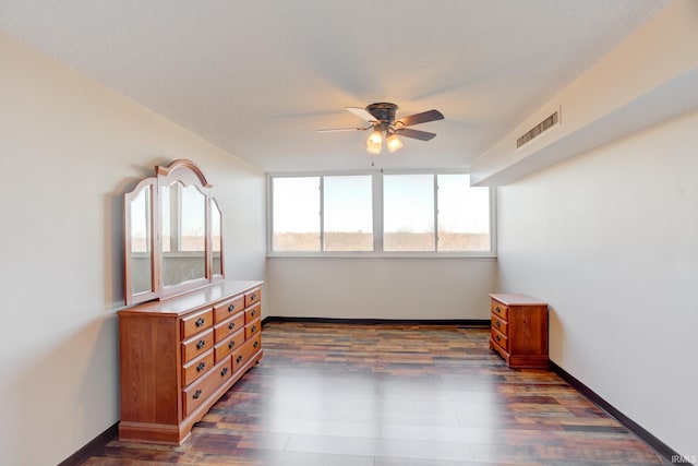 bedroom with visible vents, baseboards, ceiling fan, and dark wood-style flooring