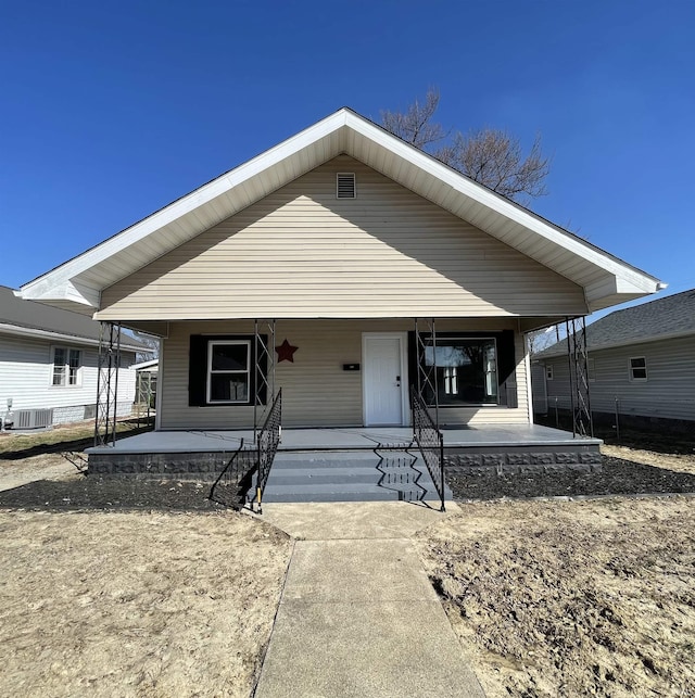 bungalow-style home with central air condition unit and covered porch