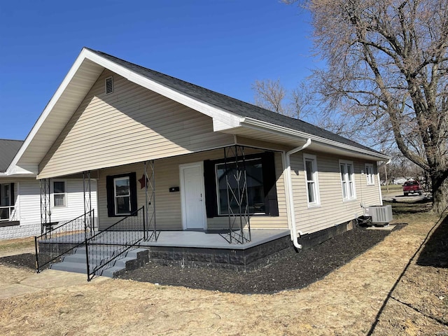 view of front facade featuring a porch and central air condition unit