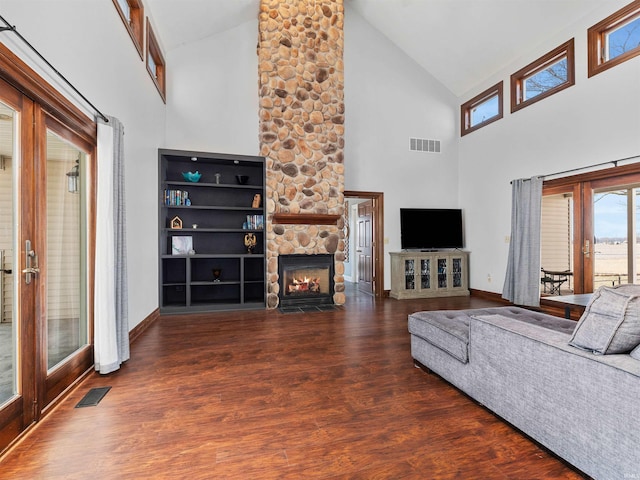 unfurnished living room featuring a fireplace, french doors, and visible vents