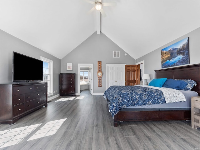 bedroom with visible vents, beamed ceiling, high vaulted ceiling, wood finished floors, and ceiling fan