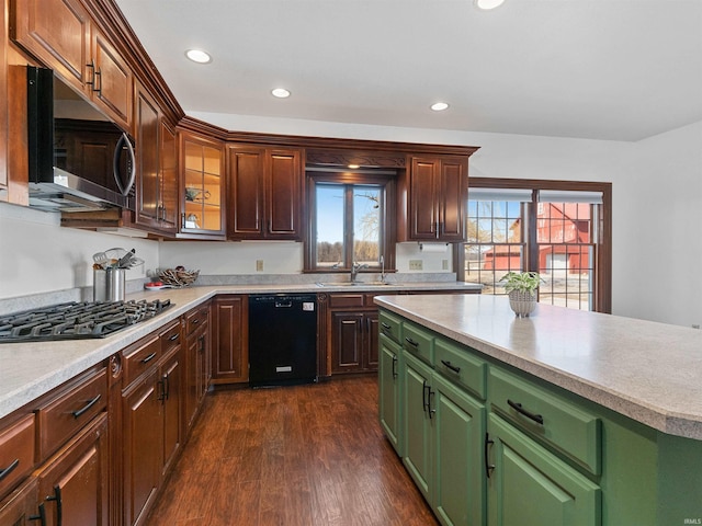 kitchen with a sink, stainless steel microwave, gas cooktop, light countertops, and dishwasher