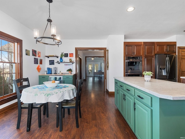 dining area featuring recessed lighting, beverage cooler, an inviting chandelier, and dark wood finished floors