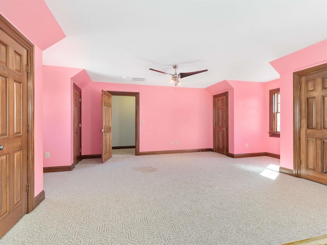 empty room featuring visible vents, baseboards, light colored carpet, and ceiling fan