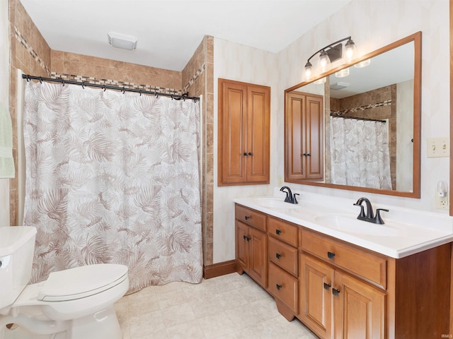 full bathroom featuring double vanity, toilet, a shower with curtain, and a sink