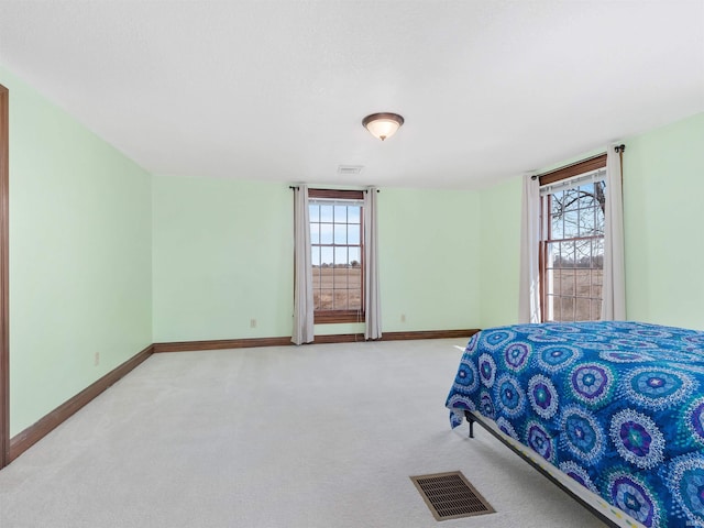 bedroom featuring multiple windows, baseboards, and visible vents