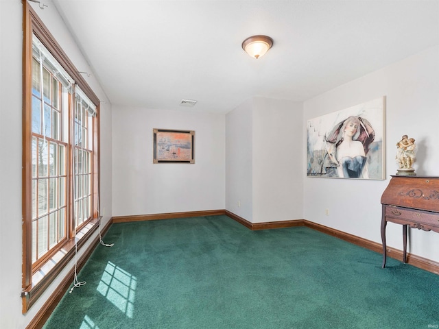 carpeted empty room with visible vents and baseboards