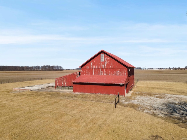 view of barn featuring a rural view and a lawn