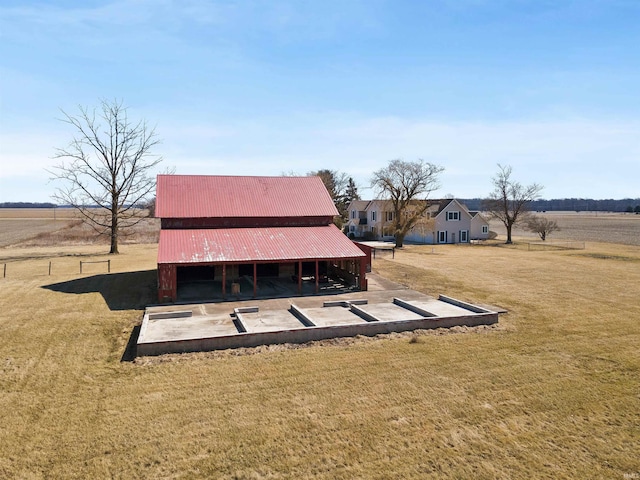 exterior space with an outbuilding, a lawn, and metal roof