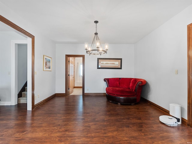 sitting room featuring stairs, wood finished floors, and baseboards