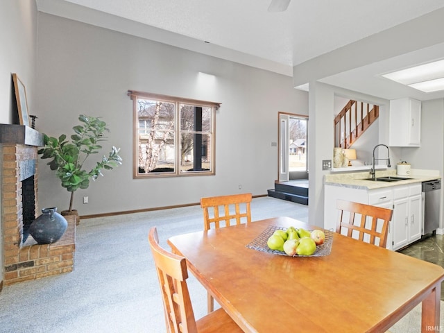 dining room featuring stairs, a brick fireplace, baseboards, and dark carpet