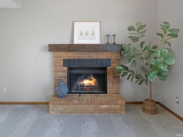 details featuring carpet flooring, a brick fireplace, and baseboards