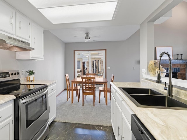 kitchen with a ceiling fan, a sink, white cabinets, electric stove, and under cabinet range hood