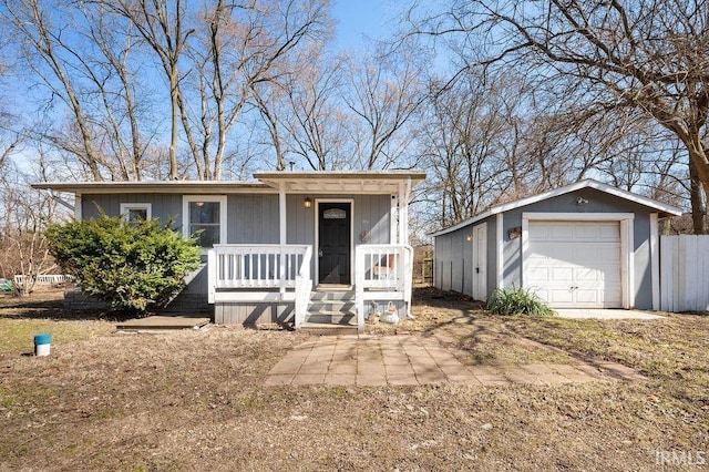 view of front of home featuring a porch, an outbuilding, and a detached garage