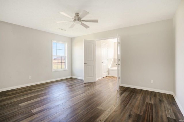 unfurnished room with visible vents, a ceiling fan, baseboards, and dark wood-style flooring