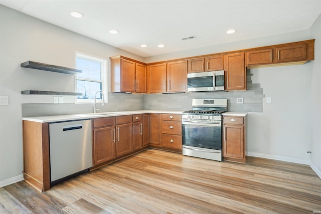 kitchen featuring brown cabinetry, visible vents, stainless steel appliances, and open shelves