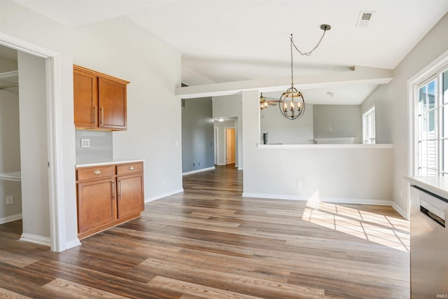 interior space featuring visible vents, a notable chandelier, wood finished floors, baseboards, and vaulted ceiling