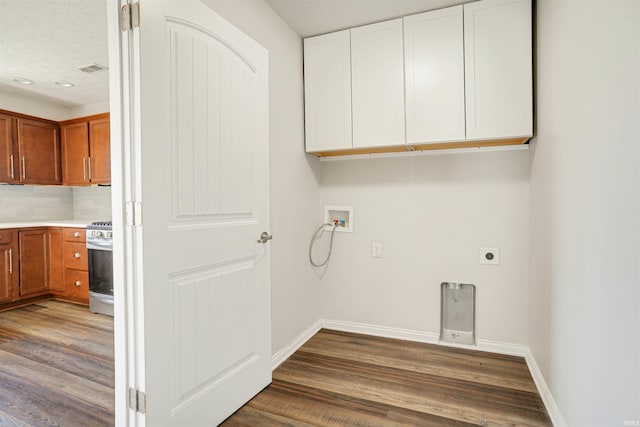 washroom with electric dryer hookup, wood finished floors, cabinet space, baseboards, and hookup for a washing machine