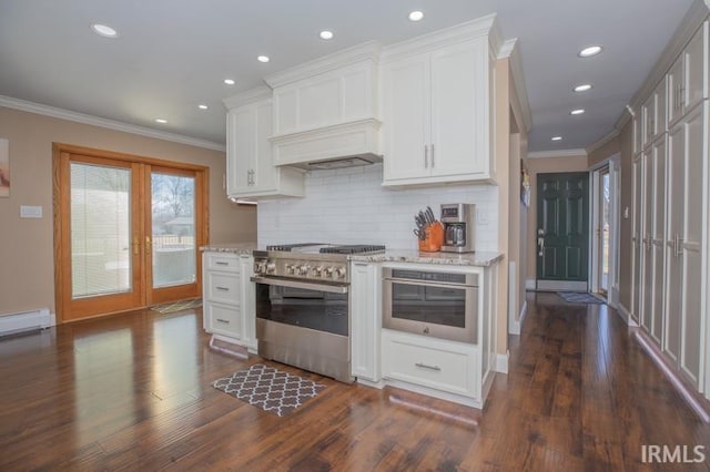 kitchen featuring high end stainless steel range oven, light stone counters, french doors, and dark wood-style flooring