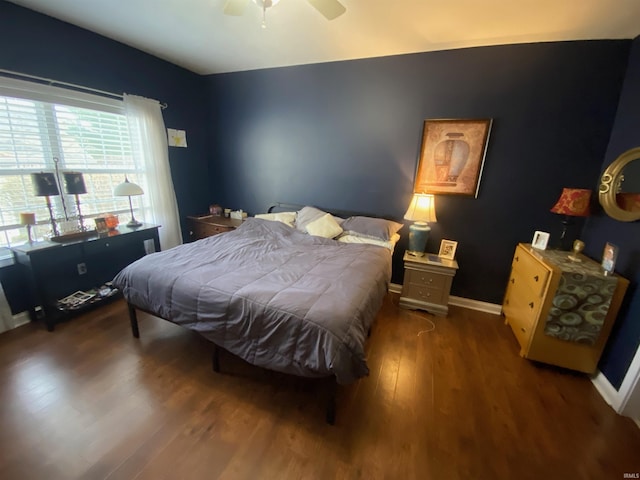 bedroom featuring ceiling fan, baseboards, and wood finished floors