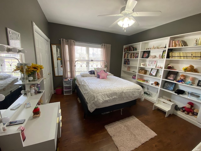 bedroom featuring dark wood-style floors, a closet, and ceiling fan