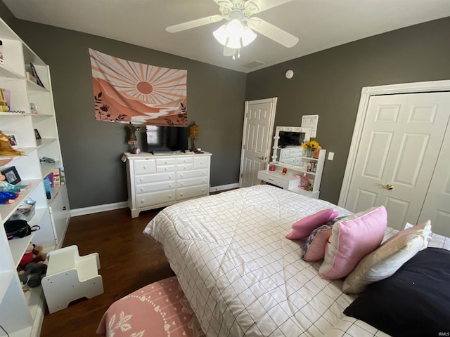 bedroom with dark wood finished floors, ceiling fan, and baseboards