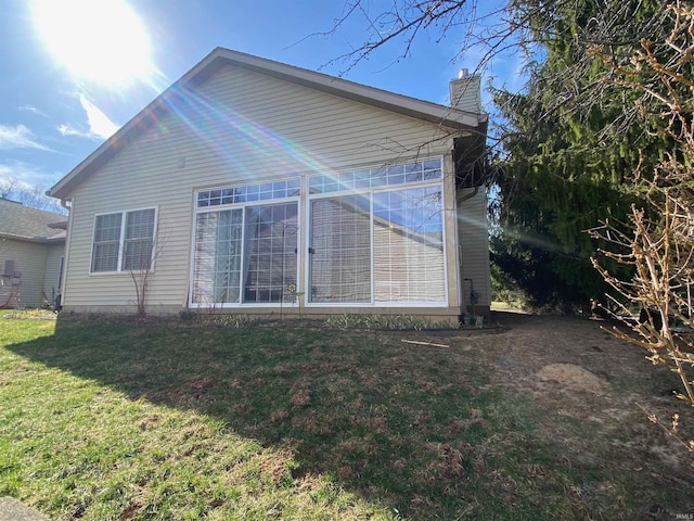 view of side of home featuring a yard