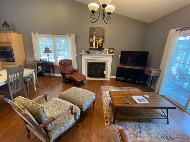 living area featuring lofted ceiling, wood finished floors, and a fireplace