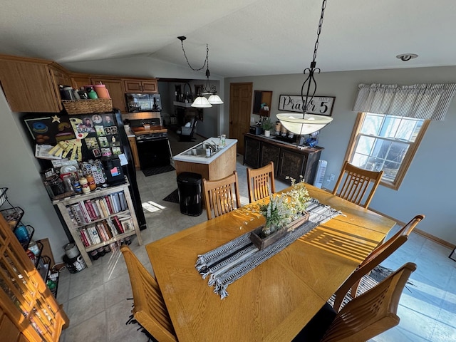 dining space with light tile patterned floors and vaulted ceiling