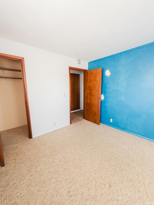 unfurnished bedroom featuring a closet and carpet