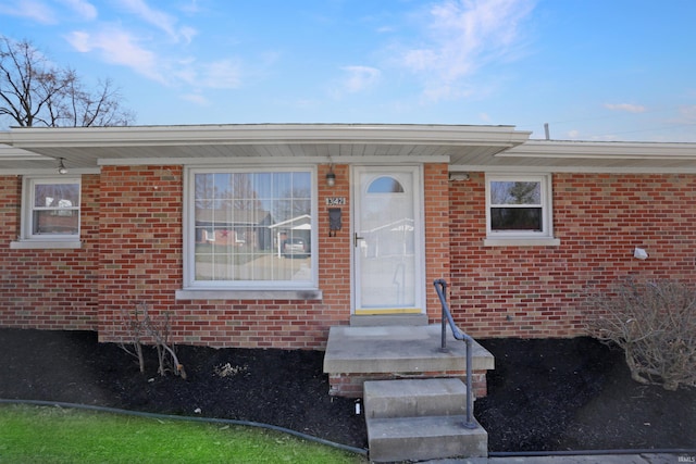 property entrance with brick siding